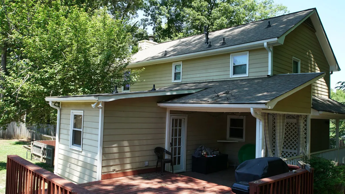 Before: the rear with an open covered patio.