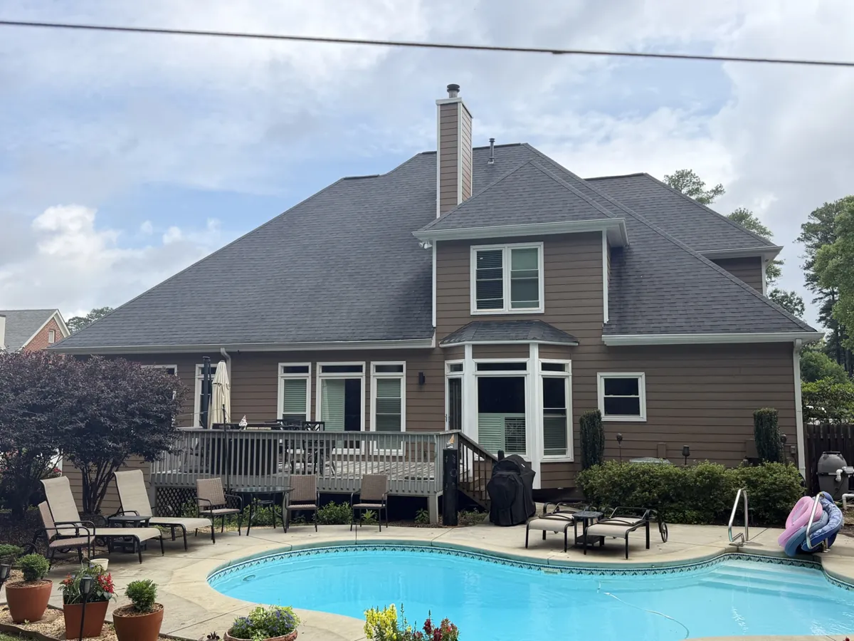 After: the same back wall in new lap siding and white trim.