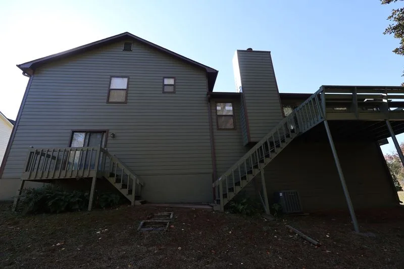 After: the same rear elevation with new siding and trim.