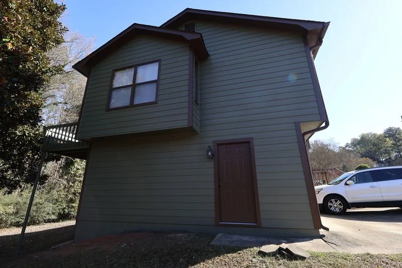 After: the same side with new siding and trim.