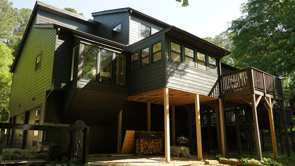 After: the same rear elevation in the new charcoal siding.
