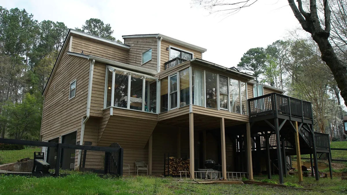 Before: the rear elevation and deck in the old siding.