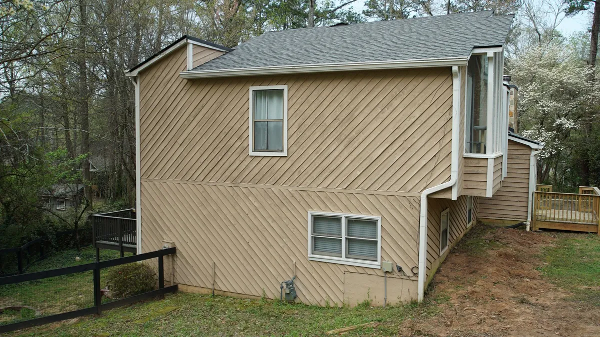 Before: side wall in the original diagonal siding.