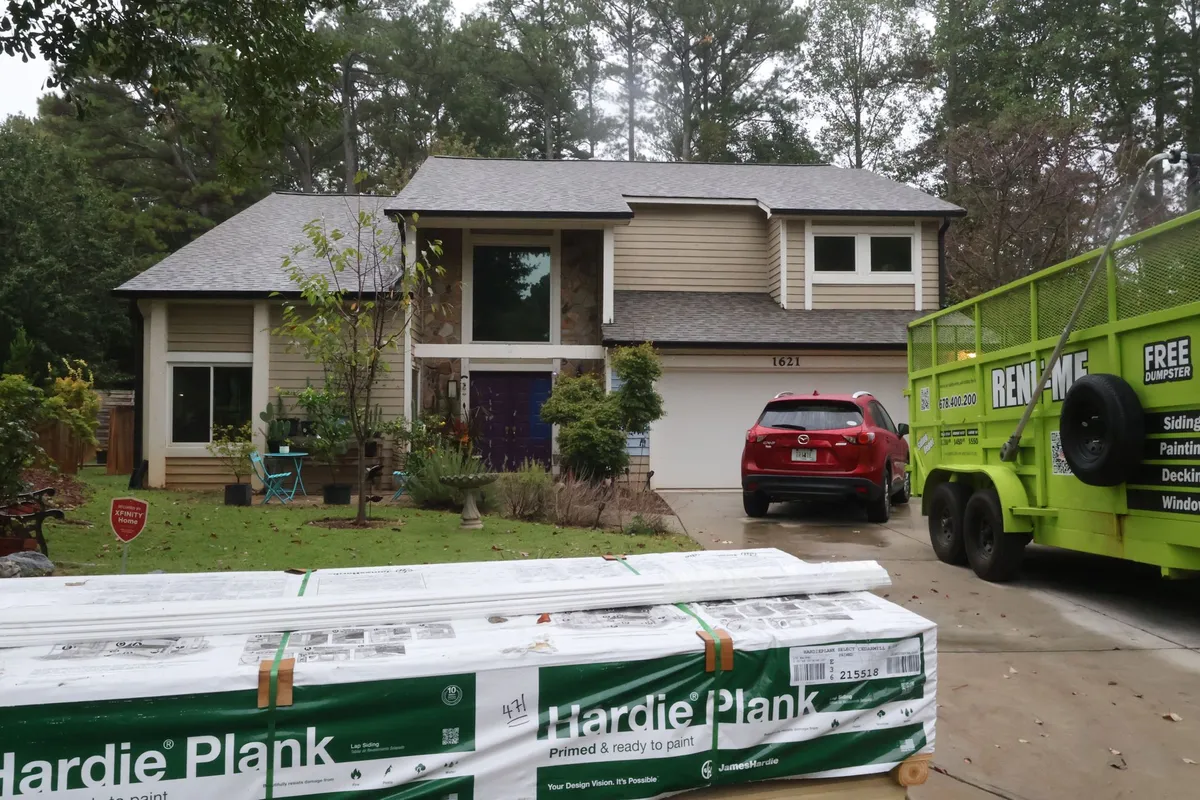 Before: beige siding on the front, HardiePlank delivered on site.