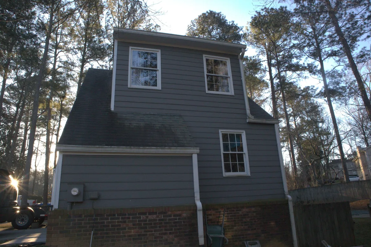 Before: side of the garage wing in dark siding.