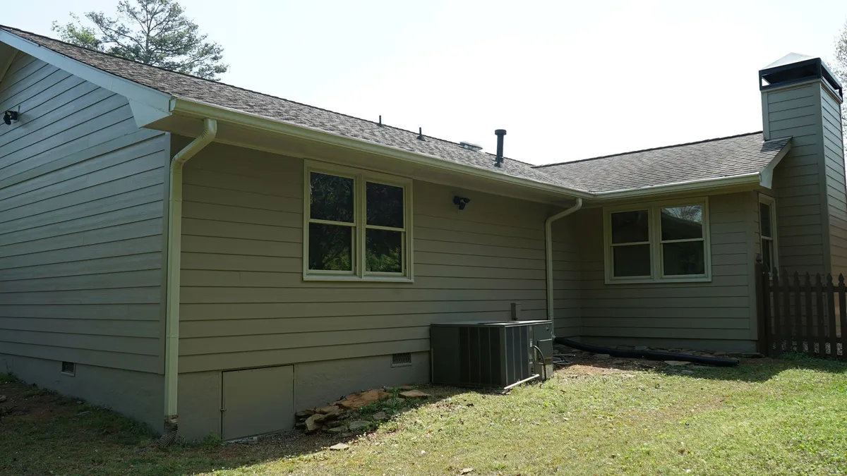 After: the same rear elevation in new lap siding.