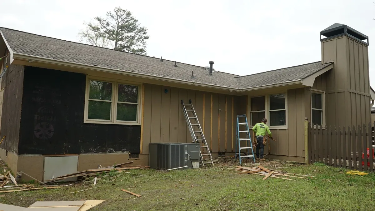 Before: the rear of the house as the old siding came off.