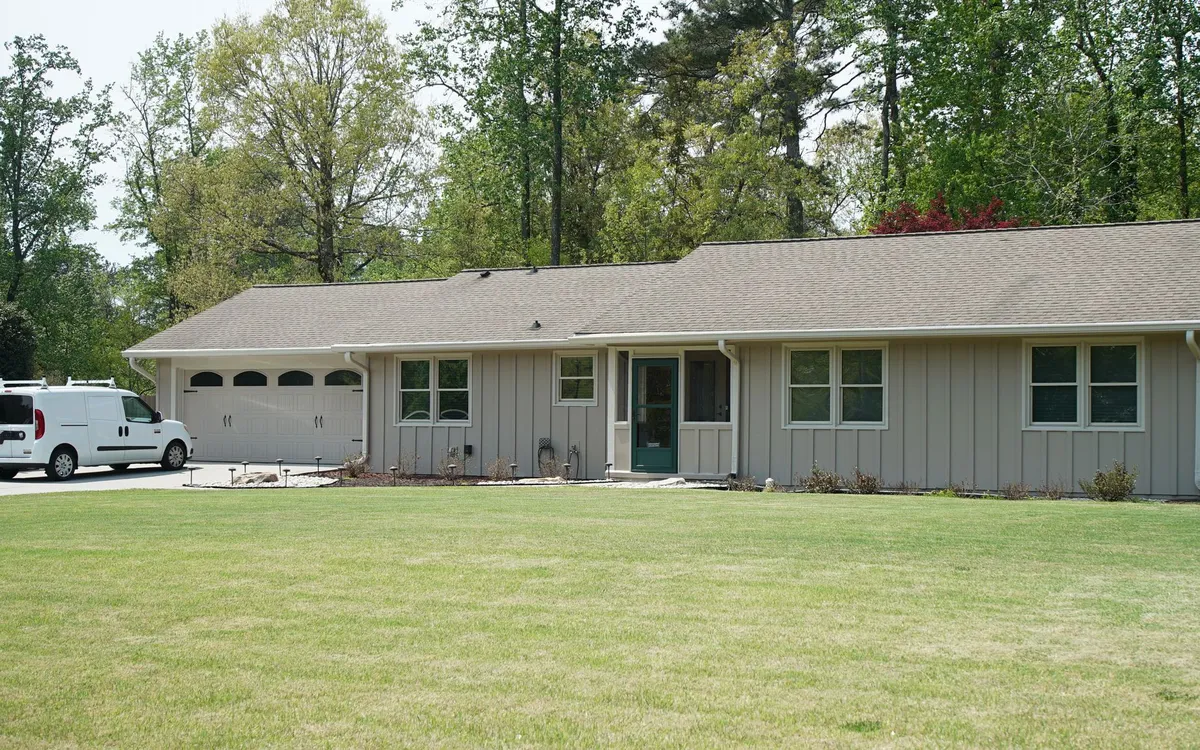 After: new board & batten in gray-taupe with white trim.