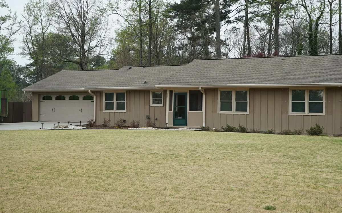 Before: faded tan board & batten on the front.