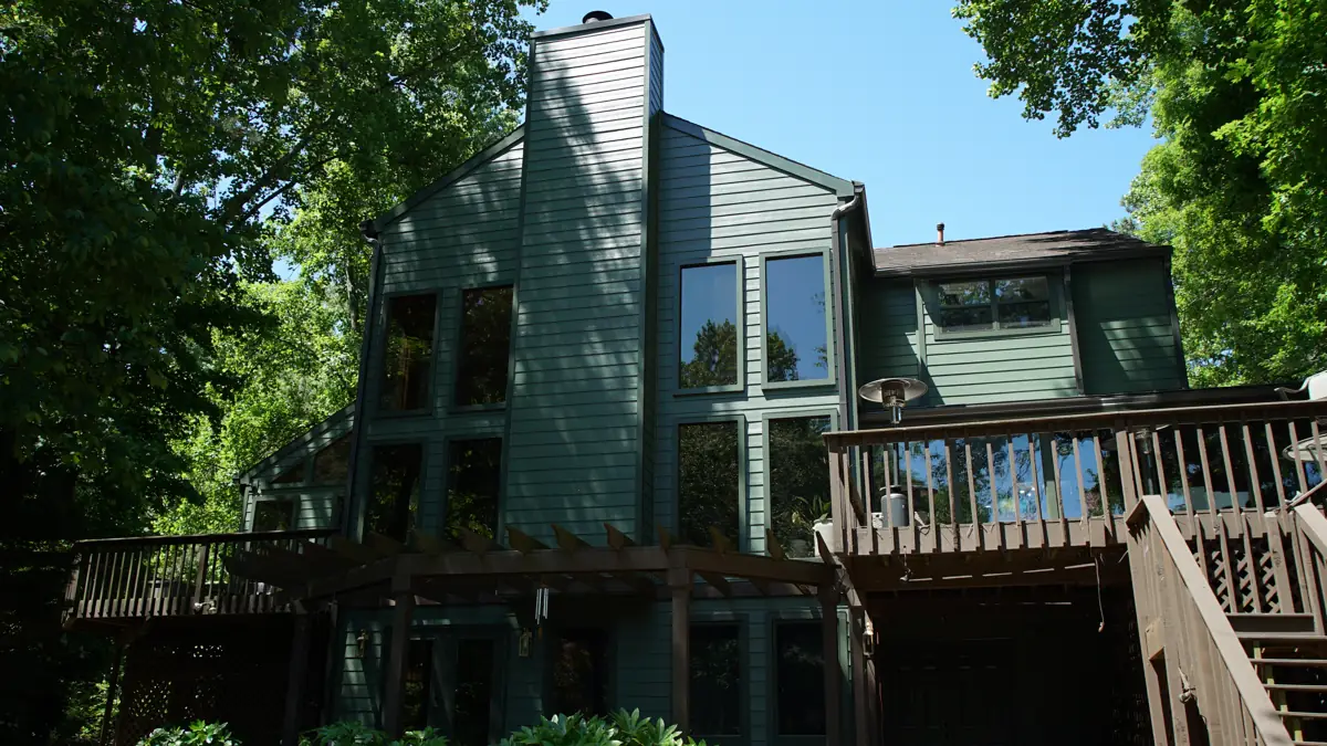 After: Back of a two-story Roswell home with a tall chimney and deck