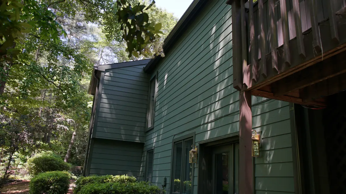 After: Side of a two-story Roswell home with a stone base