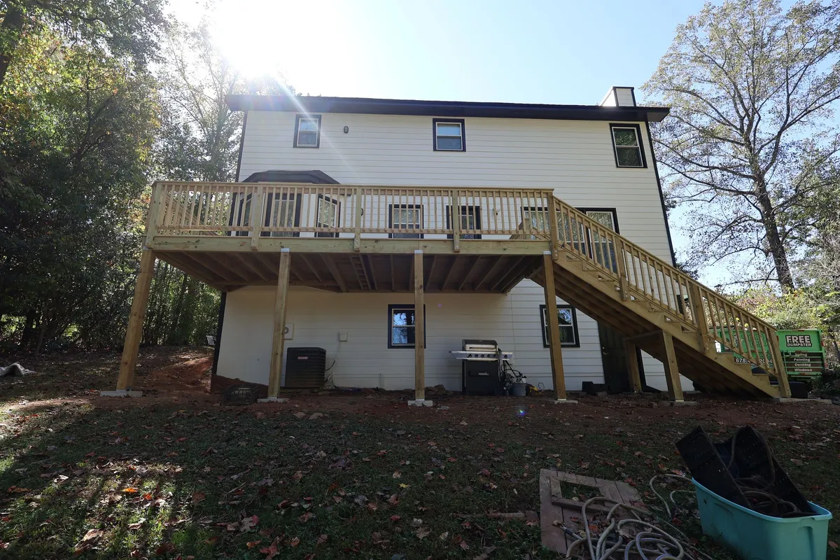 After: the same rear elevation with the new deck-side siding.