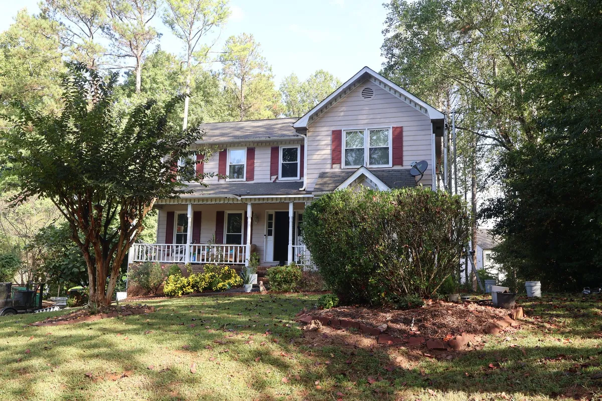 Before: faded siding and red shutters.