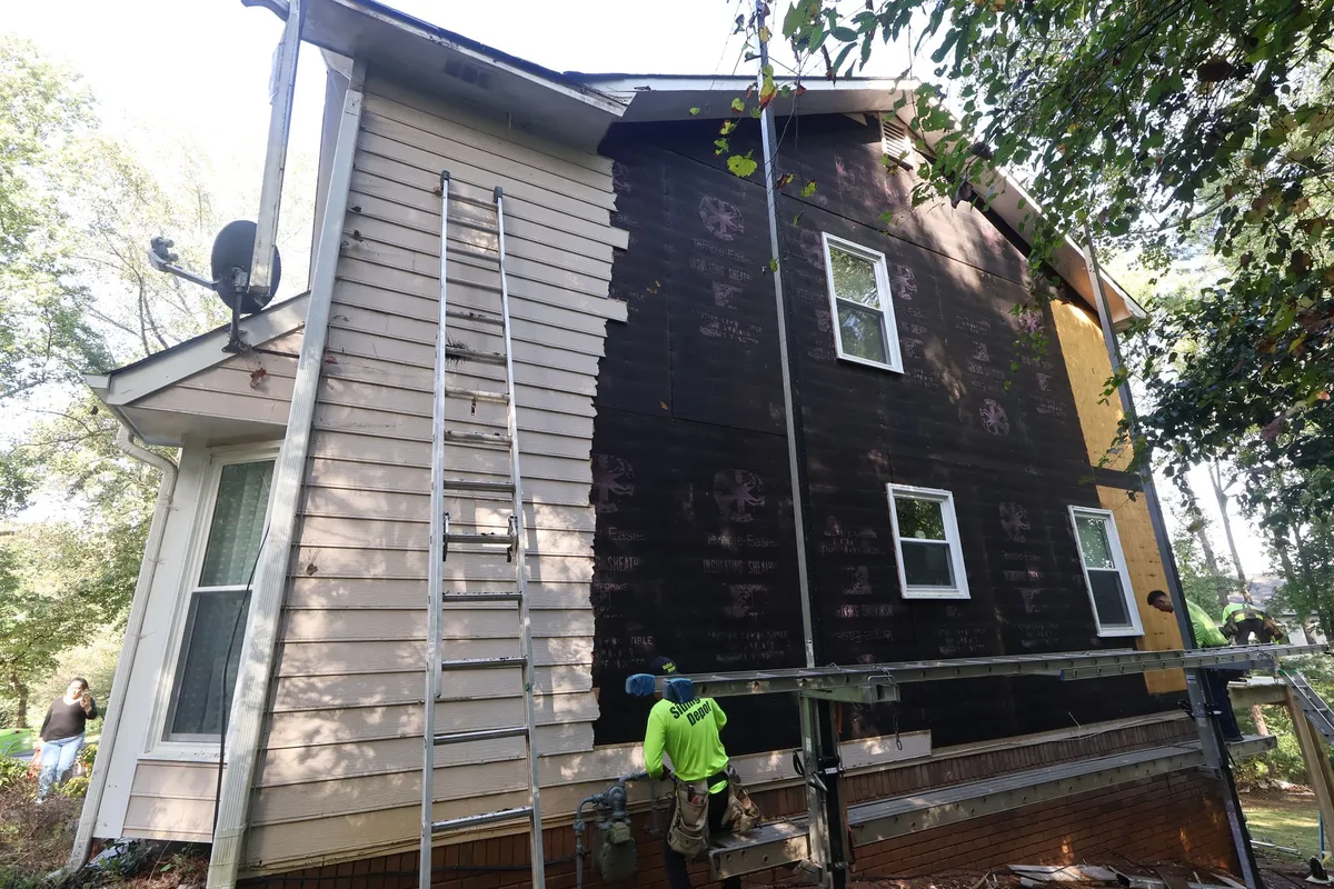 Before: side wall with the old siding coming off.